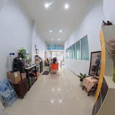 a large white hallway with a table and chairs at Hotel premier in Patong Beach