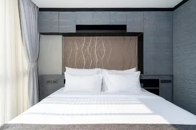 a bedroom with a large bed with white pillows at Tropics Kamala 2BR Pool View Apartment CTG B705-6 in Kamala Beach