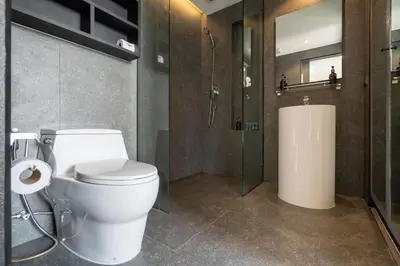 a bathroom with a toilet and a shower and a sink at Tropics Kamala 2BR Pool View Apartment CTG B705-6 in Kamala Beach