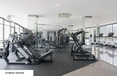 a gym with rows of treadmills and machines at Tropics Kamala 2BR Pool View Apartment CTG B705-6 in Kamala Beach