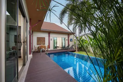 a swimming pool in front of a house at Villa Ikaroa Private pool villa Kokyang Estate in Nai Harn Beach