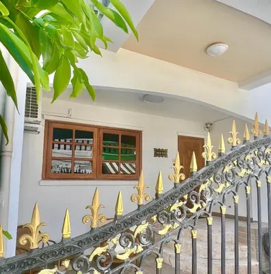 a golden fence in front of a house at Solene Home Patong in Patong Beach