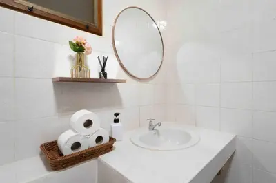 a bathroom with a sink and a mirror and towels at Solene Home Patong in Patong Beach