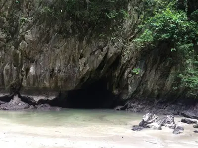 a cave on the beach in front of a rock wall at 53ft Sailing Yacht PHUKET Family Sailing adventure in Bang Tao Beach