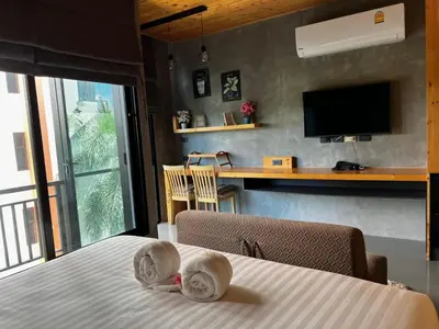a bedroom with a bed with two dolls on it at Relife The Windy in Phuket Town