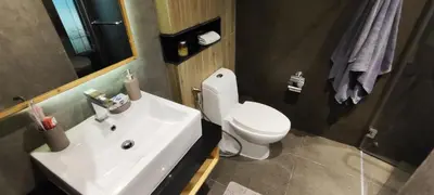 a bathroom with a white sink and a toilet at Relife The Windy in Phuket Town