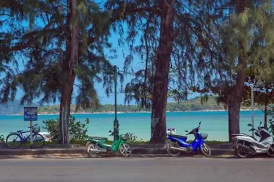 a row of motorcycles parked next to a lake at The Title Rawai Beach front 2BD in Rawai Beach