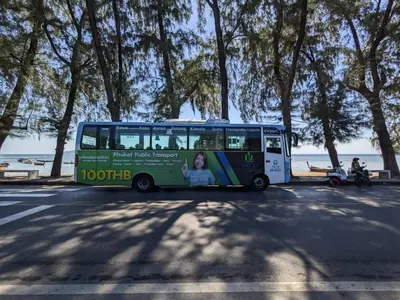a bus parked in a parking lot next to the beach at The Title Rawai Beach front 2BD in Rawai Beach