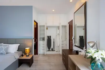 a living room with a bed and a mirror at Utopia Naiharn in Nai Harn Beach