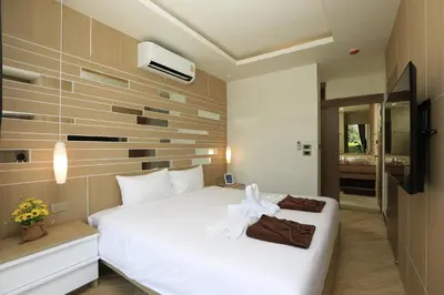 a bedroom with a white bed in a room at Calypso Garden by Holy Cow, 1-BR, private terrace in Rawai Beach