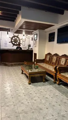 a room with couches and a table in a room at Relax Guest House in Patong Beach