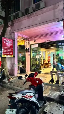 a scooter parked in front of a store at Relax Guest House in Patong Beach