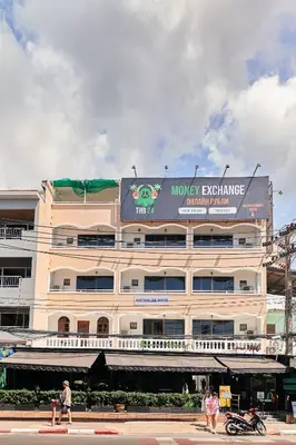 a large white building with a sign on it at Lime Hotel in Patong Beach