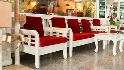 a store with red and white chairs and tables at Lime Hotel in Patong Beach