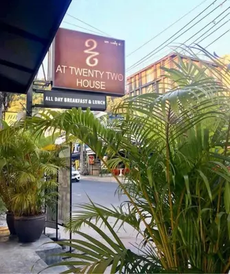 an at twenty two house sign on a building with plants at Twenty Two House in Patong Beach