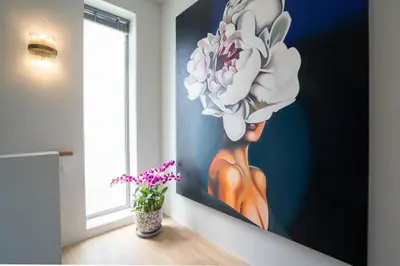 a painting of a woman with a flower on a wall at Himmapana Villas - Hills in Kamala Beach