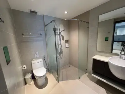 a bathroom with a shower and a toilet and a sink at Emerald Terrace Condo 3-Studio Garden Gem in Patong Beach