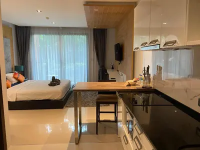 a kitchen and a bedroom with a bed and a table at Emerald Terrace Condo 5-Studio Garden zen in Patong Beach