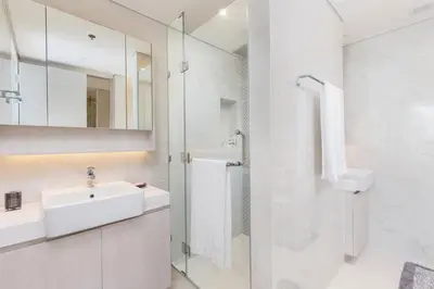 a white bathroom with a sink and a shower at Cassia Residence Laguna Phuket Holiday Rental Apartment, Bang Tao Beach in Phuket Town