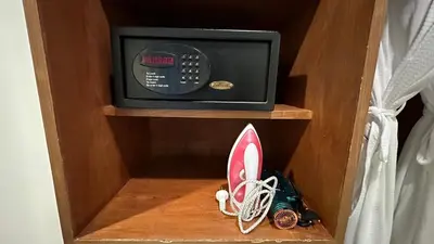 a wooden drawer with a microwave in a room at COZY Residence Patong in Patong Beach