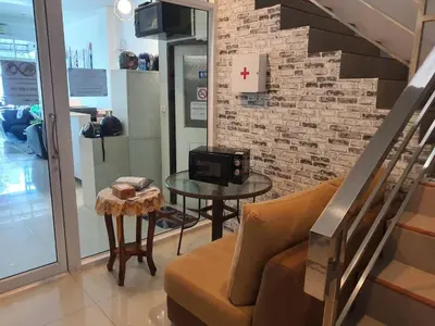 a living room with a couch and a table at COZY Residence Patong in Patong Beach
