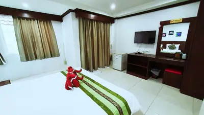 a bedroom with a bed and a desk and a television at Nanai 8 Road \u82ad\u4e1c\u4e00\u5367\u8c6a\u534e\u516c\u5bd3\u4f4d\u7f6e\u4fbf\u5229 in Patong Beach