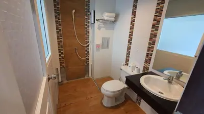 a bathroom with a shower and a toilet and a sink at Fruit Paradise in Patong Beach