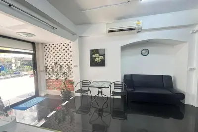 a living room with a couch and chairs and a table at Sonya Residence in Patong Beach