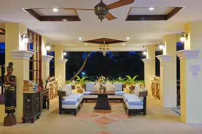 a living room with a couch and a table and chairs at Anyavee Aonang Bay in Ao Nang Beach