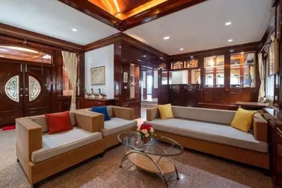 a living room with two couches and a glass table at Cheeva Pool Villa Phuket in Phuket Town