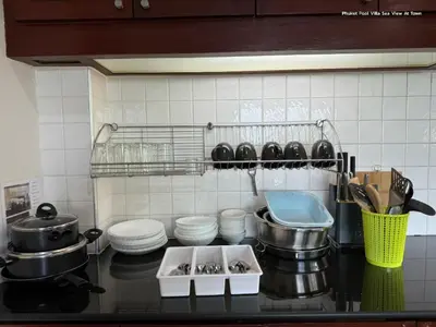 a kitchen with a counter with pots and pans at Cheeva Pool Villa Phuket in Phuket Town