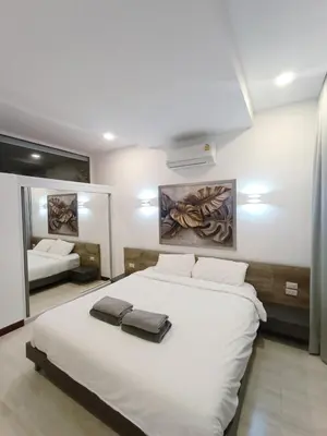 a bedroom with a large white bed and a mirror at Smart Conzept 2bdr 300m to the sea in Kata Beach