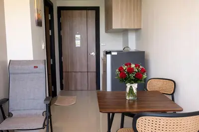a vase of flowers on a table in a kitchen at MaiKhao Sunrise Sight Space in Ban Mai Salae
