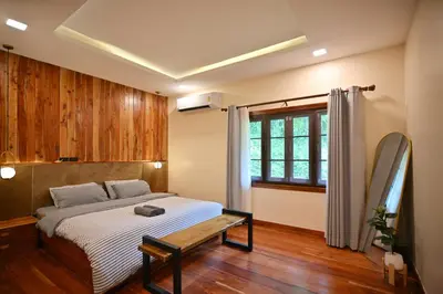 a bedroom with a bed and a window at The Moonlight Guesthouse in Patong Beach