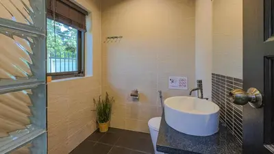 a bathroom with a sink and a toilet at Garden bungalows 4br with private pool in Rawai Beach