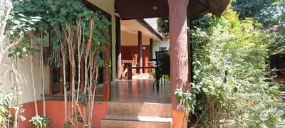 a front porch of a house with trees at Baan Suan Villas Resort in Ban Suan