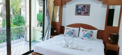 a bedroom with a bed with a white bow on it at AINNY Residence in Patong Beach