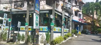 a building with signs on the side of a street at AINNY Residence in Patong Beach