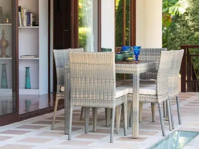 a dining room table and chairs on a patio at Infinity View by Elite Havens in Kata Beach