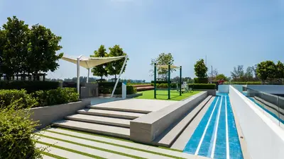 a swimming pool with stairs and a playground at Уютные апартаменты в Laguna Skypark in Phuket Town