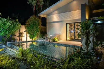 a swimming pool in front of a house at night at Villa Charming - Lovely 2 bedrooms house with pool in Rawai Beach