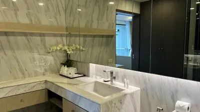 a bathroom with a sink and a mirror at Mida Grande Apartment with Rooftop Pool near Surin Beach in Surin Beach