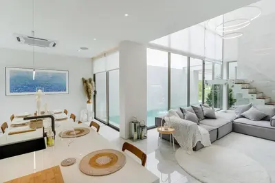 a living room with a couch and a table at The Residence by Andaman Villa in Phuket Town
