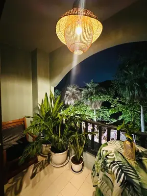 a room with plants on a balcony with a chandelier at MILD ROOM SEA VIEW ROOM FOR RENT in Phi Phi Don