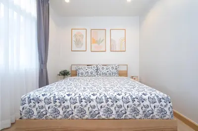 a bedroom with a bed with a blue and white bedspread at 2BR Homey townhome 350M walk to Kata Beach Fully equipped in Kata Beach