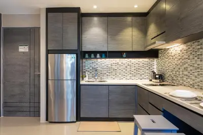 a kitchen with a stainless steel refrigerator at 5 Stars Facilities Condo Kamala Beach in Kamala Beach