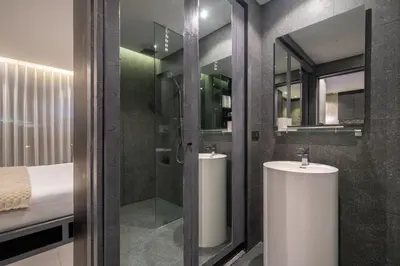 a bathroom with two sinks and a shower and a bed at 5 Stars Facilities Condo Kamala Beach in Kamala Beach