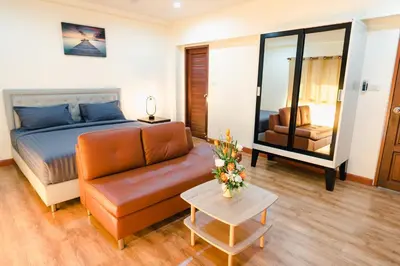 a living room with a couch and a bed at Kai Mook House in Ban Ket Ho